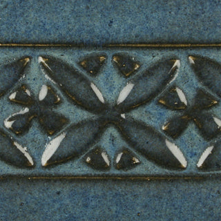 Blue Midnight is a glossy black glaze with blue highlights in thick areas, ideal for textured work and layering. Amaranth Stoneware Canada.