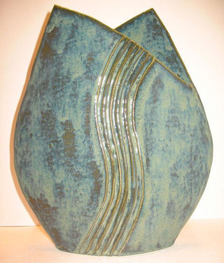 A deep, mottled green glaze that creates a rich variegated surface, especially when paired with the Archie's Base. Amaranth Stoneware Canada.