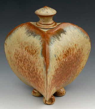 A golden cream glaze with reddish brown streaks. Can show blue crystals and varies widely in color and finish. Amaranth Stoneware Canada.