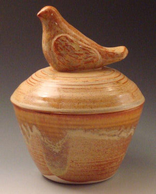 A golden cream glaze with reddish brown streaks. Can show blue crystals and varies widely in color and finish. Amaranth Stoneware Canada.