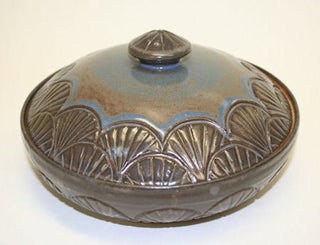 Piece by Cathy Cozart. Blue Shino glaze, dark blue where thick and reddish-brown where thin. Amaranth Stoneware Canada.