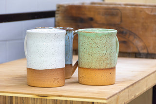 Practical Bee mugs: speckled tan clay, farmhouse-inspired glazes, microwave/dishwasher safe, 4.5" x 3". Handmade in Kingston, Ontario at Amaranth Stoneware.