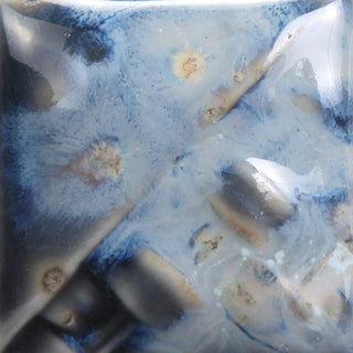 Cone 6: Semi-transparent charcoal gloss glaze with a three-tone crystal of white, orange, and blue; showcases more blue hues with melted crystals at Cone 10. Amaranth Stoneware Canada.