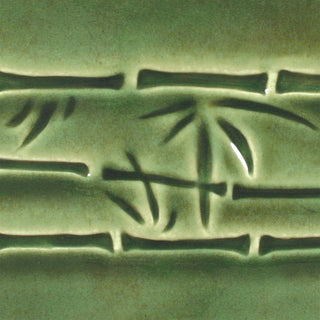Dark green is a fluid, translucent emerald glaze that shows off textured and carved ware. Amaranth Stoneware Canada.