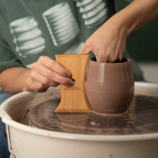 The Wine Tumbler Tool shapes perfect stemless wine glasses with two curved sides for red, white, or bubbles. 5” x 3.5”, made of maple wood. Handmade in St. Louis, MO. Amaranth Stoneware Canada.