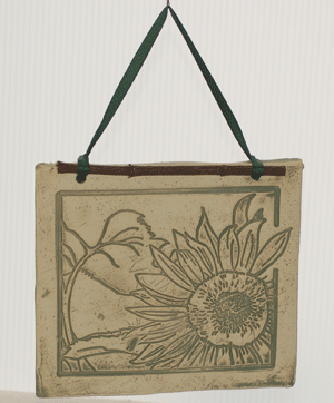 Handcrafted 4x4-inch stoneware Botanicals featuring seasonal plants and creatures. Finished with dogwood and ribbon. Weatherproof. Handcrafted in Kingston, Ontario at Amaranth Stoneware.