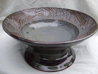 A mottled greyish blue glaze that offers surface variety like Pam's Green but with a softer color. Amaranth Stoneware Canada.