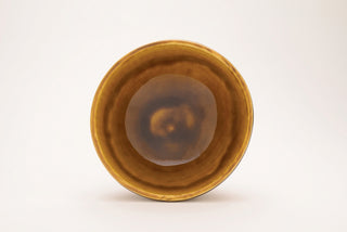 Amber glaze, a semi-transparent, glossy golden finish, appears light gold on porcelain, darker on white clay, and deep gold on red clay. Amaranth Stoneware Canada.