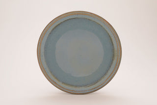 Arctic Blue glaze, a glossy, opaque light blue on white clay, and green-blue on red clay, breaks brown over texture. Amaranth Stoneware Canada.