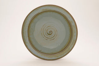 Arctic Blue glaze, a glossy, opaque light blue on white clay, and green-blue on red clay, breaks brown over texture. Amaranth Stoneware Canada.