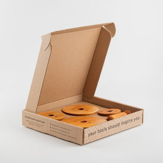 Garrity Mushroom Anvil Set includes 3", 4", 5", and 6" tops, one interchangeable handle, and eco-friendly packaging. Perfect for shaping clay slabs into dishes. Handmade in St. Louis, MO, with packaging made from 100% recycled materials. Amaranth Stoneware Canada.