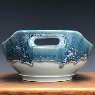 A runny pale blue glaze with icy blue crystals, especially when slow-cooled. Beautiful but requires care. Amaranth Stoneware Canada.