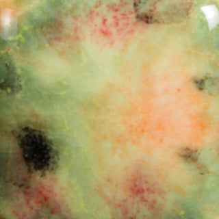 Mixed Melon translucent green with red, orange, brown crystals and black specks at cone 06. 
At Cone 6: Crystals melt, glaze fades with enhanced mobility. Amaranth Stoneware Canada.