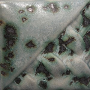 Moonscape gray to white variegation with black crystals at Cone 6; more variegation and crystals with extra coats.
At Cone 10: Gray turns blue, crystals melt. Amaranth Stoneware Canada.