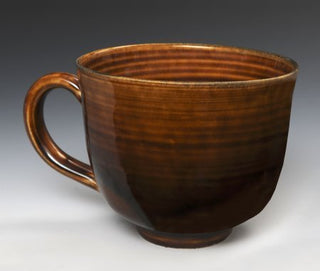 A translucent brown glaze that pools beautifully, varying from caramel to deep chestnut. Amaranth Stoneware Canada.