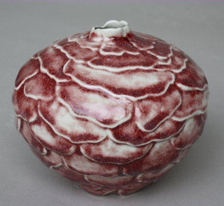 Oxblood is a specialized glaze that produces a copper red in electric kilns when applied thickly, while thinner areas appear clear or gray. Amaranth Stoneware Canada.