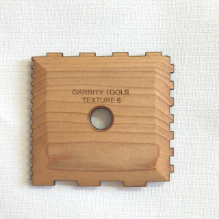 Texture 6 creates squared ridges with four sizes of geometric patterns for unique textures. 3.5" x 3.25", made of maple wood. Handmade in St. Louis, MO. Amaranth Stoneware Canada.