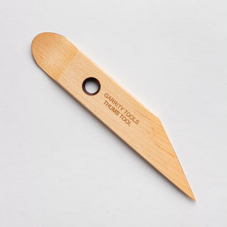The scooped end of the Thumb Tool replaces your thumb for hand-building, pressing seams, shaping slabs, or trimming pots on the wheel. 7" x 1.25", made of maple wood. Handmade in St. Louis, MO. Amaranth Stoneware Canada.