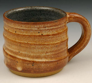 A lighter shino with orange-brown spots that breaks to brown over texture. Combines well with other glazes. Amaranth Stoneware Canada.